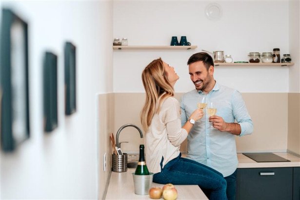 cute young couple drinking wine kitchen